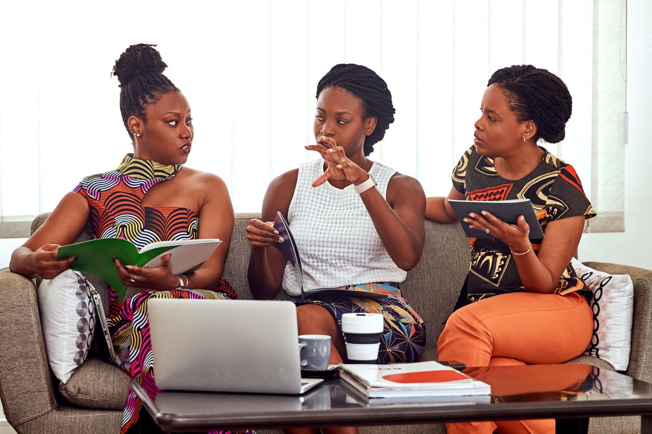 Mastering the First Impression: Your intriguing post title goes here Three African American women engaged in a collaborative business meeting indoors.